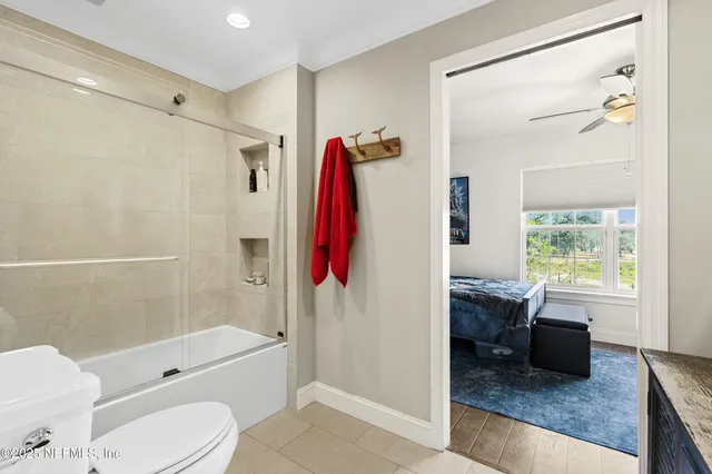 a bathroom with a toilet a sink and mirror