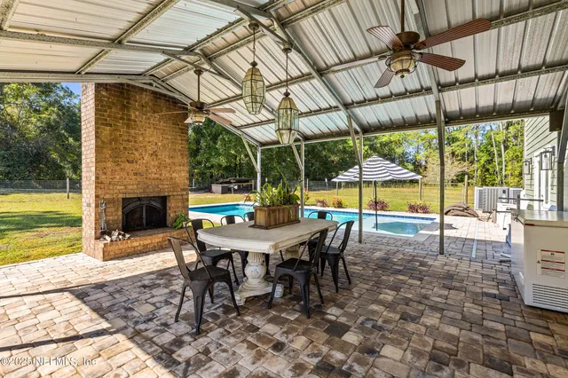 a view of swimming pool with sitting area and furniture