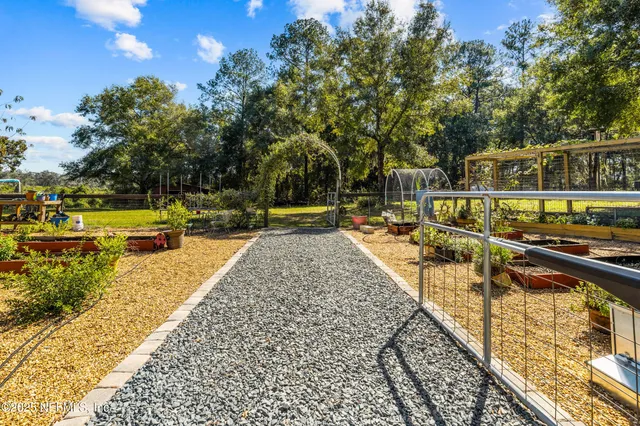 a view of a small house in middle of the forest