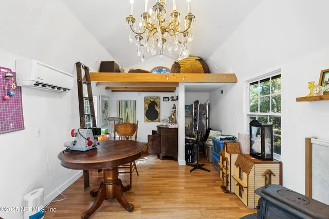 a view of a yard with plants and trees