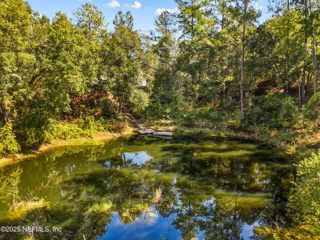 a view of a house with swimming pool and a yard