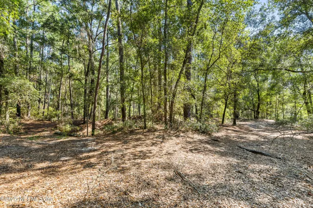 a view of a house with swimming pool and sitting area