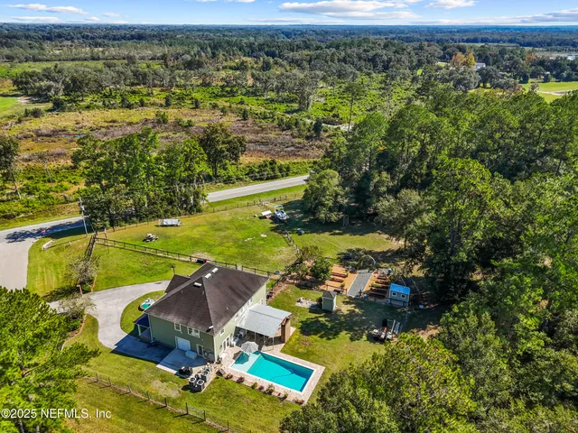 a view of a house with swimming pool and a garden