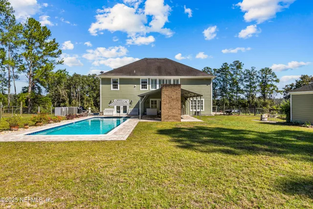 a view of a swimming pool with a yard