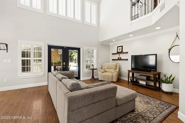 a living room with furniture floor to ceiling window and rug