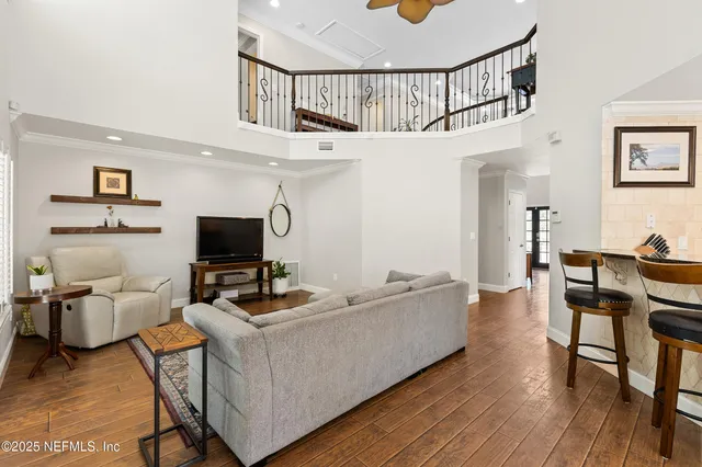a dining room with furniture and wooden floor