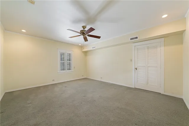 an empty room with a empty space and a ceiling fan