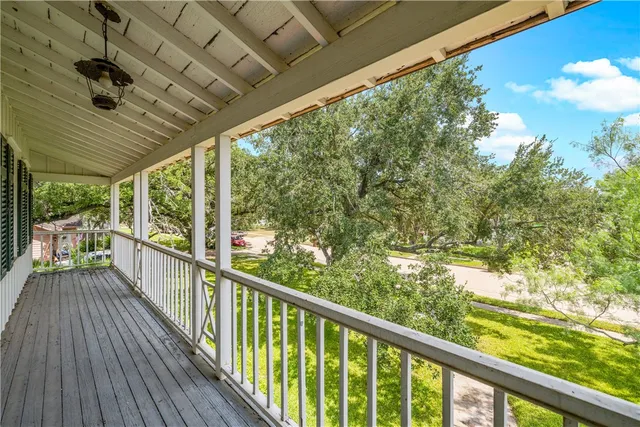 a view of balcony with wooden floor