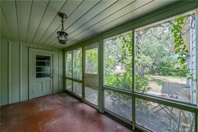 a view of a porch with furniture and garden