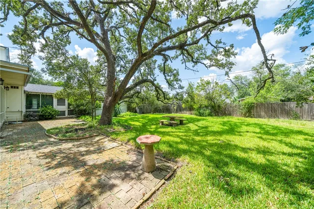 a view of a house with backyard and sitting area