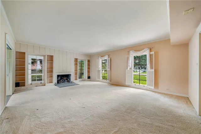 an empty room with furniture and fireplace