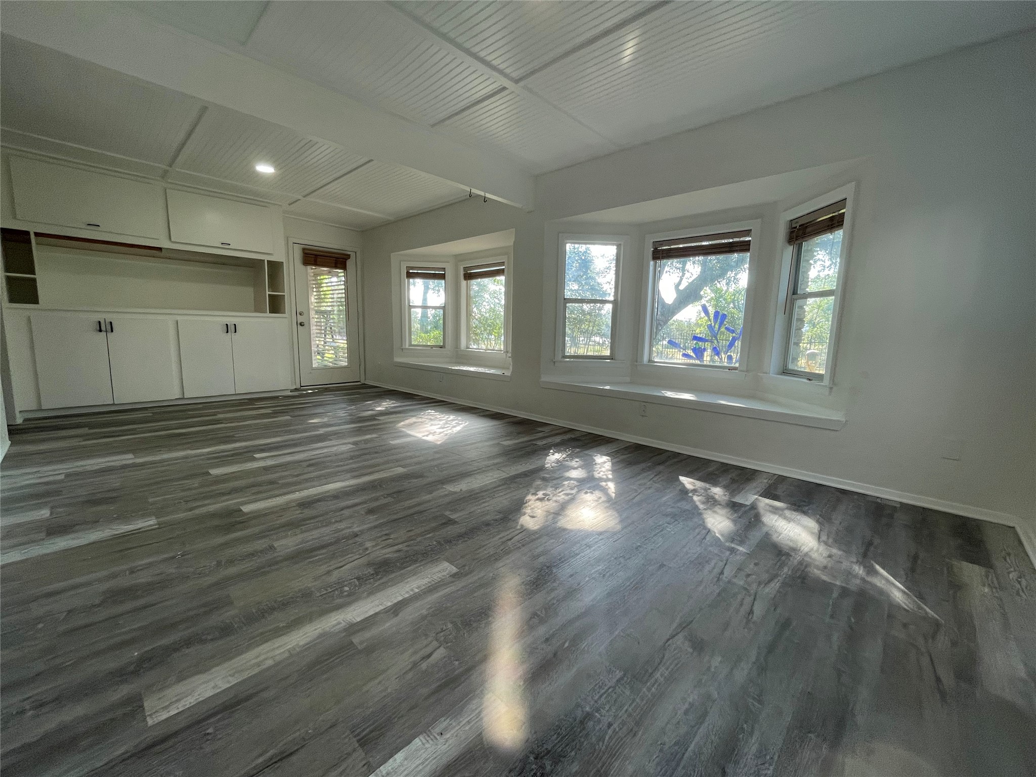 5802 Longhorn Landing Austin, TX 78734 - Photo 23 of 38 Unfurnished living room featuring dark wood-type flooring and beam ceiling