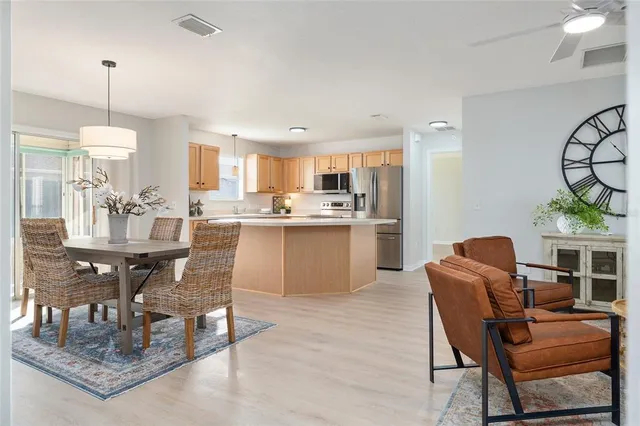 a living room with dining table and a wooden floor