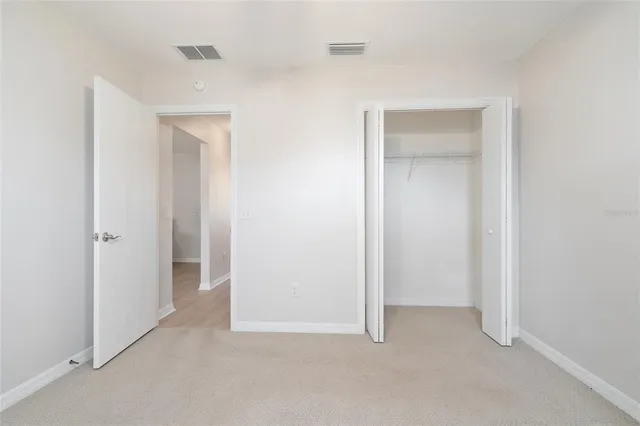 a view of an empty room and closet area