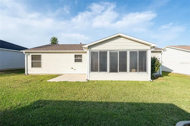 a view of a house with a yard and garage