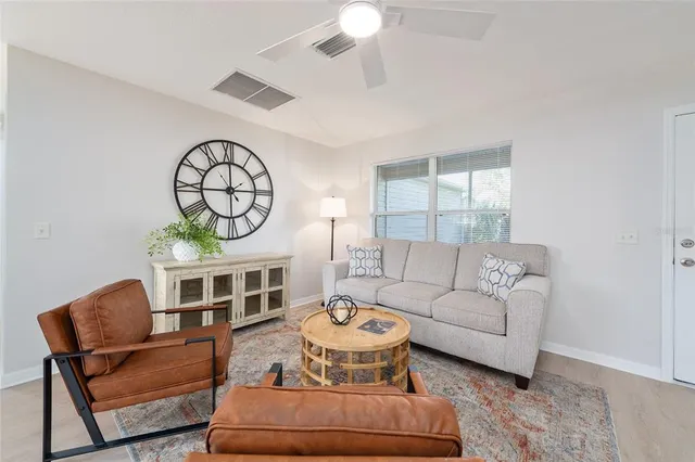 a living room with furniture a fireplace and a chandelier