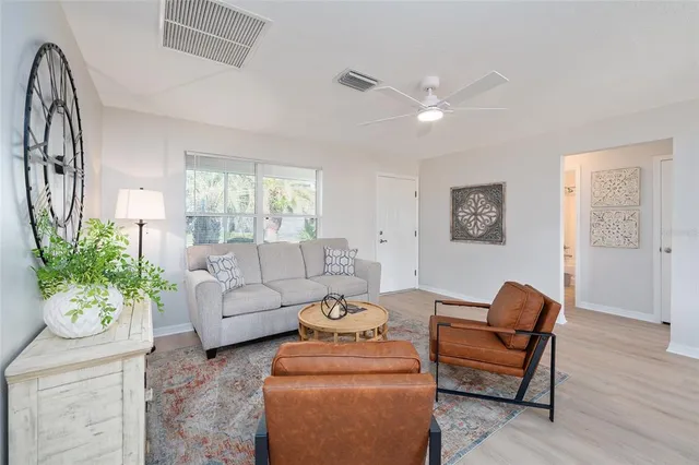 a living room with furniture and a potted plant