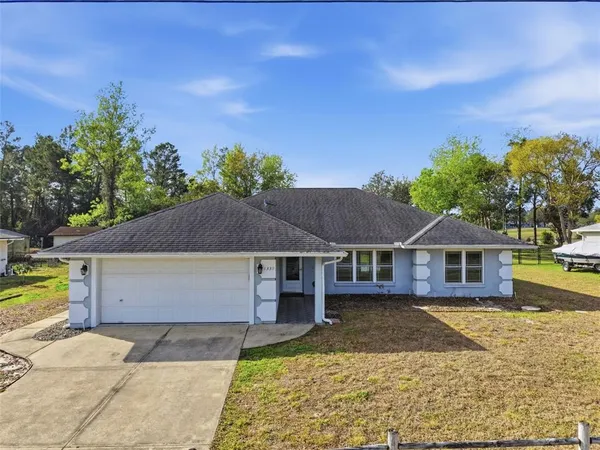 a front view of a house with a garden and yard