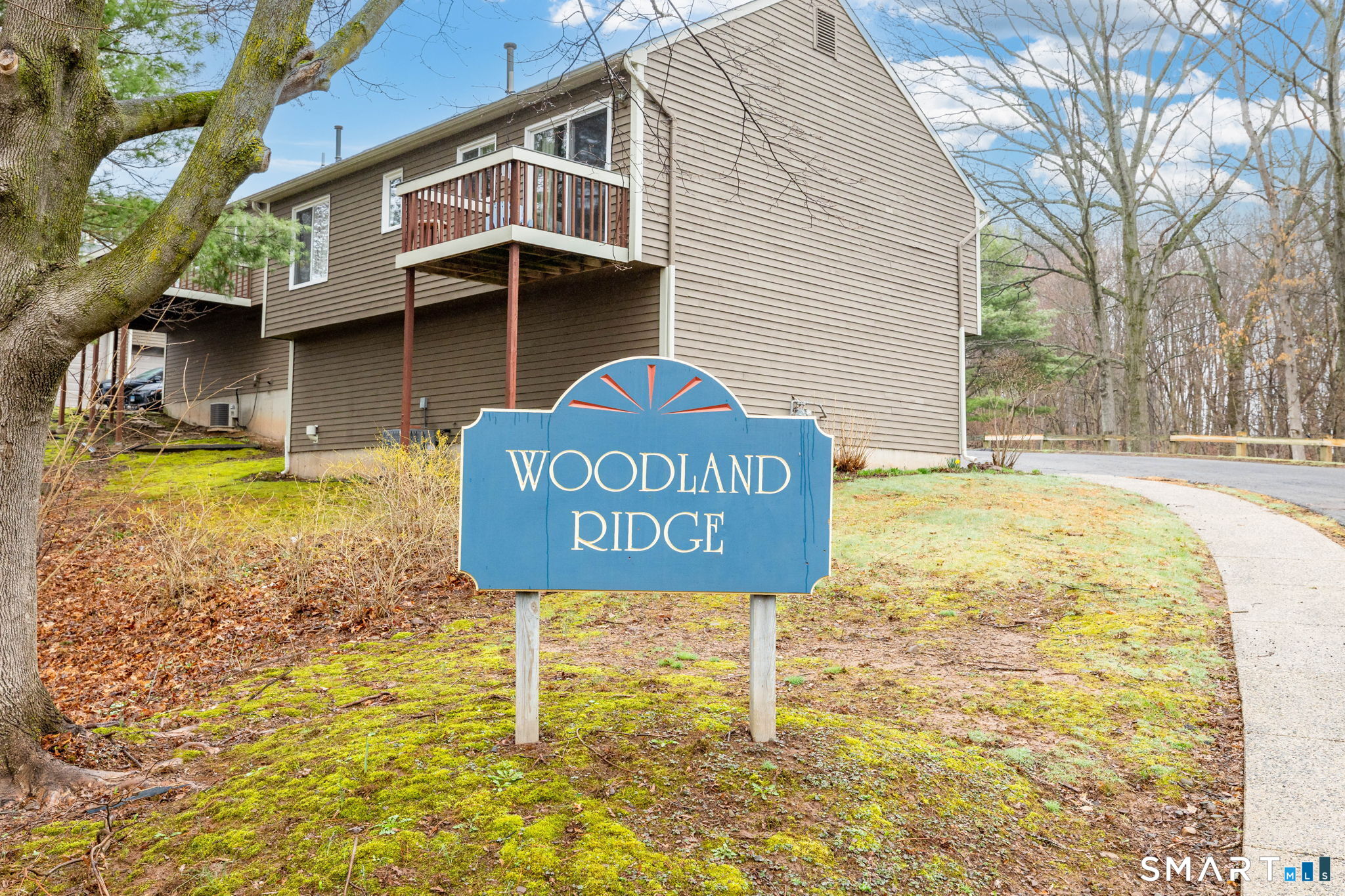 67 Woodland Ridge, Unit 67 Meriden, CT 06450 - Photo 27 of 33 a view of a street sign under a white house