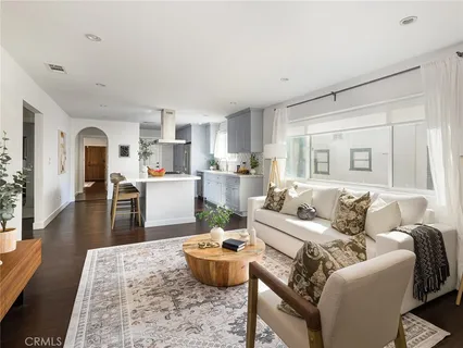 a kitchen with a dining table chairs and refrigerator