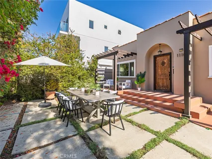 a view of a house with backyard and sitting area