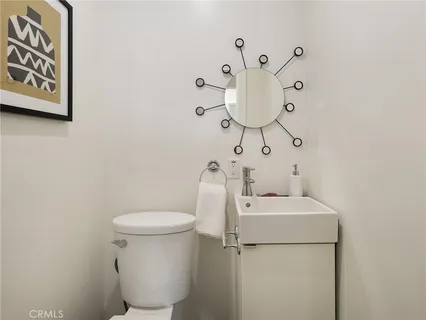 a bathroom with a granite countertop toilet sink and a mirror