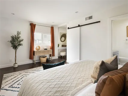 a bathroom with a granite countertop sink mirror and toilet