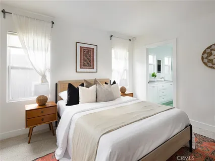 a living room with a couch and potted plant