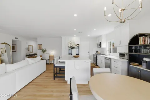 a living room with furniture and kitchen view