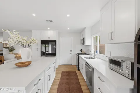 a kitchen with a sink stove and refrigerator