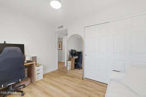 a view of a workspace with furniture and a window