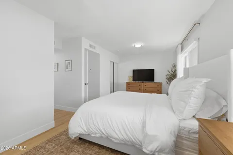 a bedroom with a bed and a flat screen tv