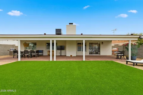 a view of a house with swimming pool and sitting area