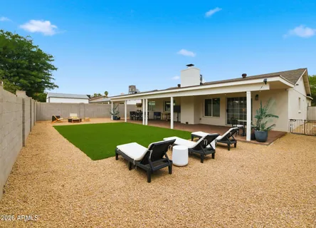 a view of a house with backyard porch and sitting area