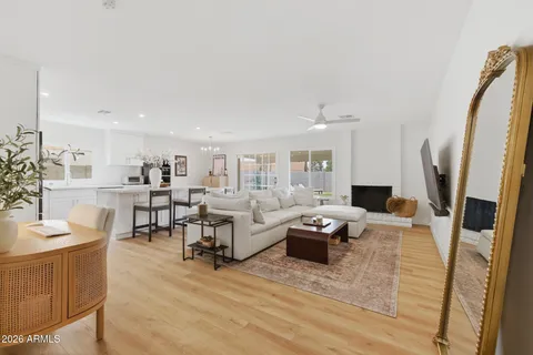 a living room with fireplace furniture and a wooden floor