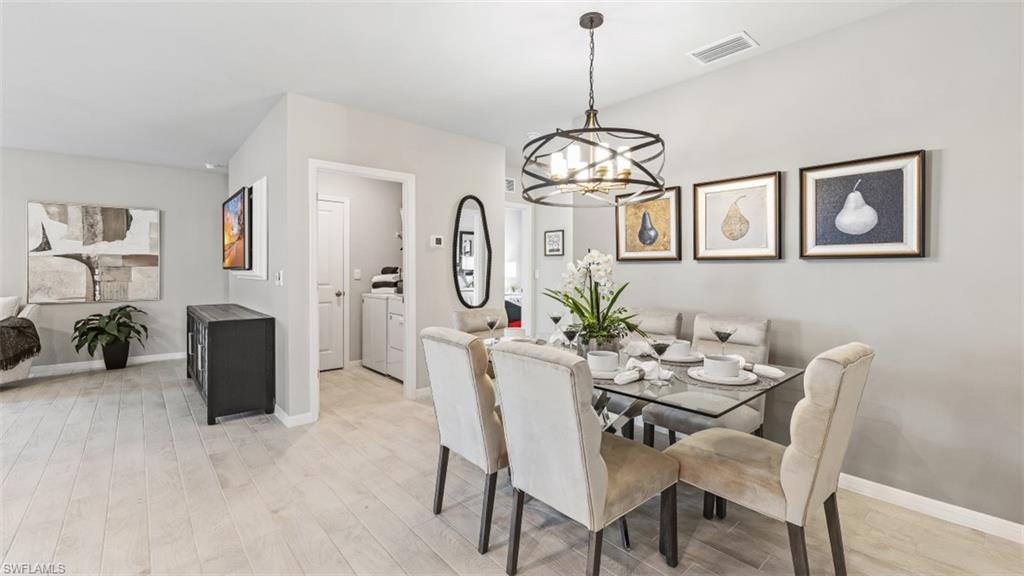 17752 Shade Tree Loop Punta Gorda, FL 33982 - Photo 7 of 40 a view of a dining room with furniture kitchen and wooden floor
