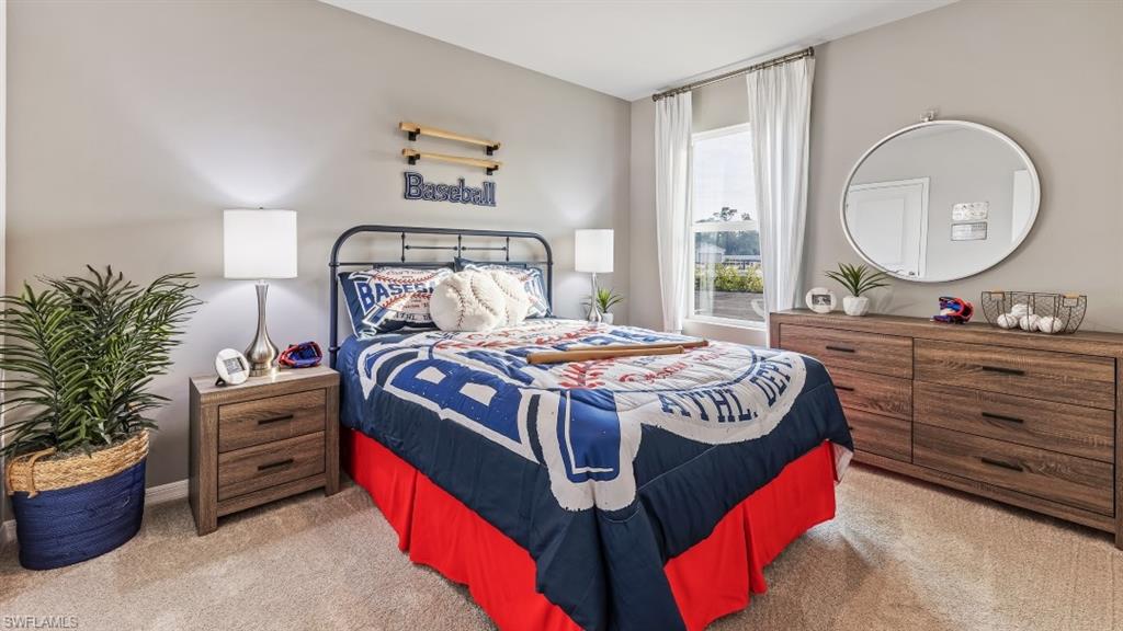 17752 Shade Tree Loop Punta Gorda, FL 33982 - Photo 8 of 40 a bed sitting in a bedroom next to a window with potted plant