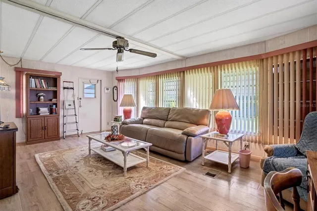 a living room with furniture a rug and a large window