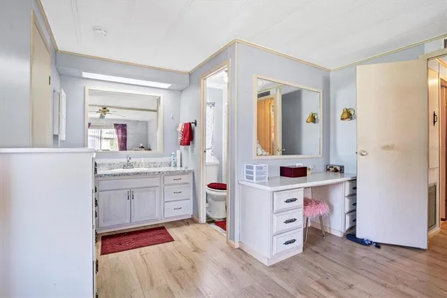 a bathroom with a granite countertop sink mirror and double