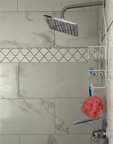 a bathroom with a shower and a shower head