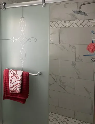 a bathroom with a granite countertop toilet sink and mirror