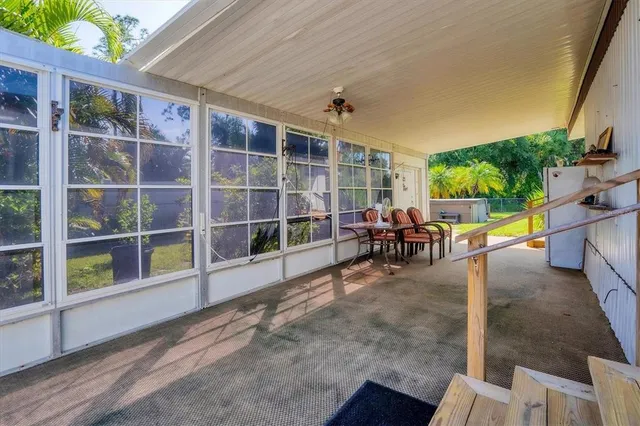 a backyard of a house with potted plants and a bench