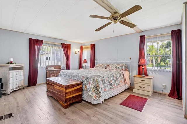 a spacious bedroom with a bed and a chandelier