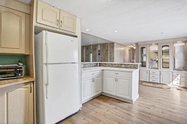 a kitchen with white cabinets and white appliances