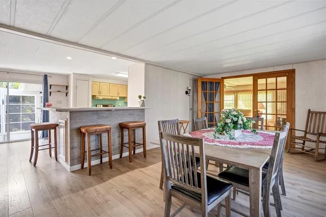 a dining room with furniture and wooden floor