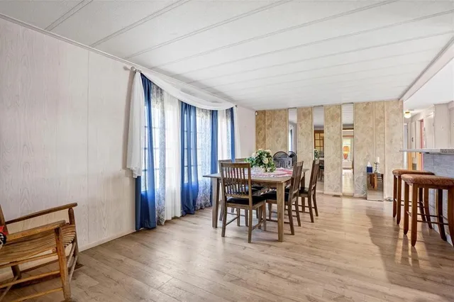 a dining room with furniture window and wooden floor