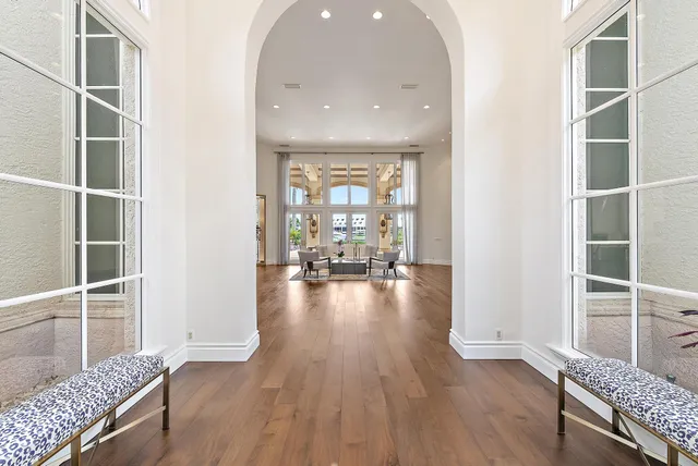 a living room with furniture and a floor to ceiling window