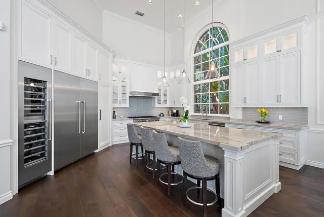 a kitchen with stainless steel appliances granite countertop a lot of counter space and wooden floors