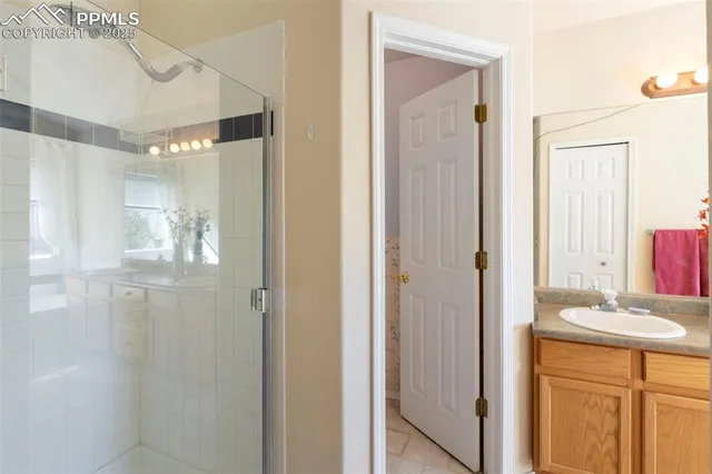a bathroom with a mirror sink and shower