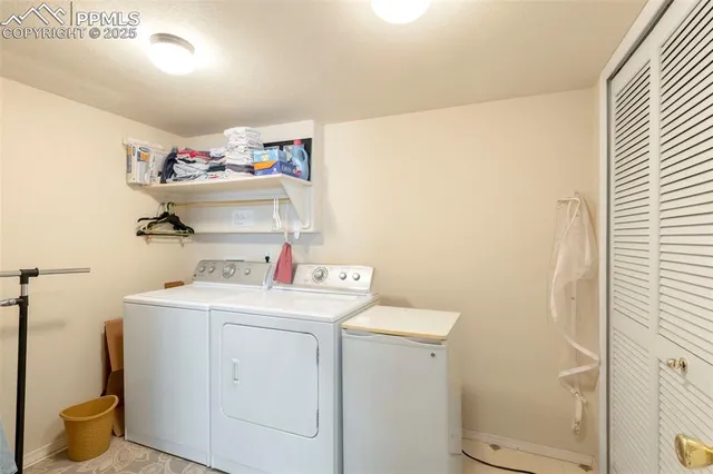 a view of a storage & utility room with dryer and washer